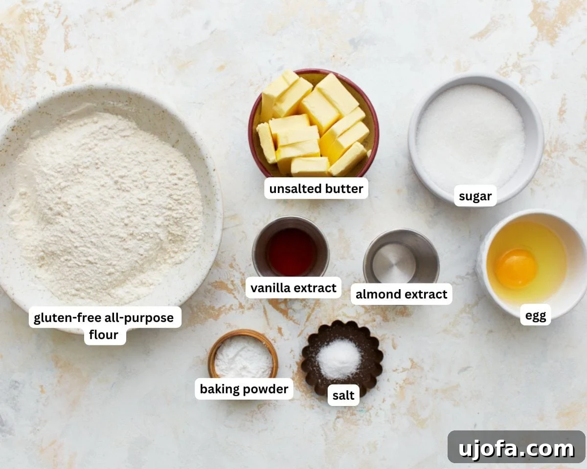 Simply Sweet Gluten-Free Cookies 3 A collection of the essential ingredients for gluten-free sugar cookies, including butter, sugar, flour, extracts, and egg, neatly arranged for preparation.