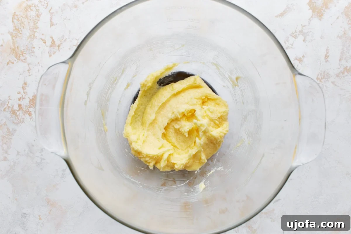 Simply Sweet Gluten-Free Cookies 8 A large egg, pure vanilla extract, and almond extract have just been added to the creamed butter and sugar mixture in a glass bowl, ready to be beaten.