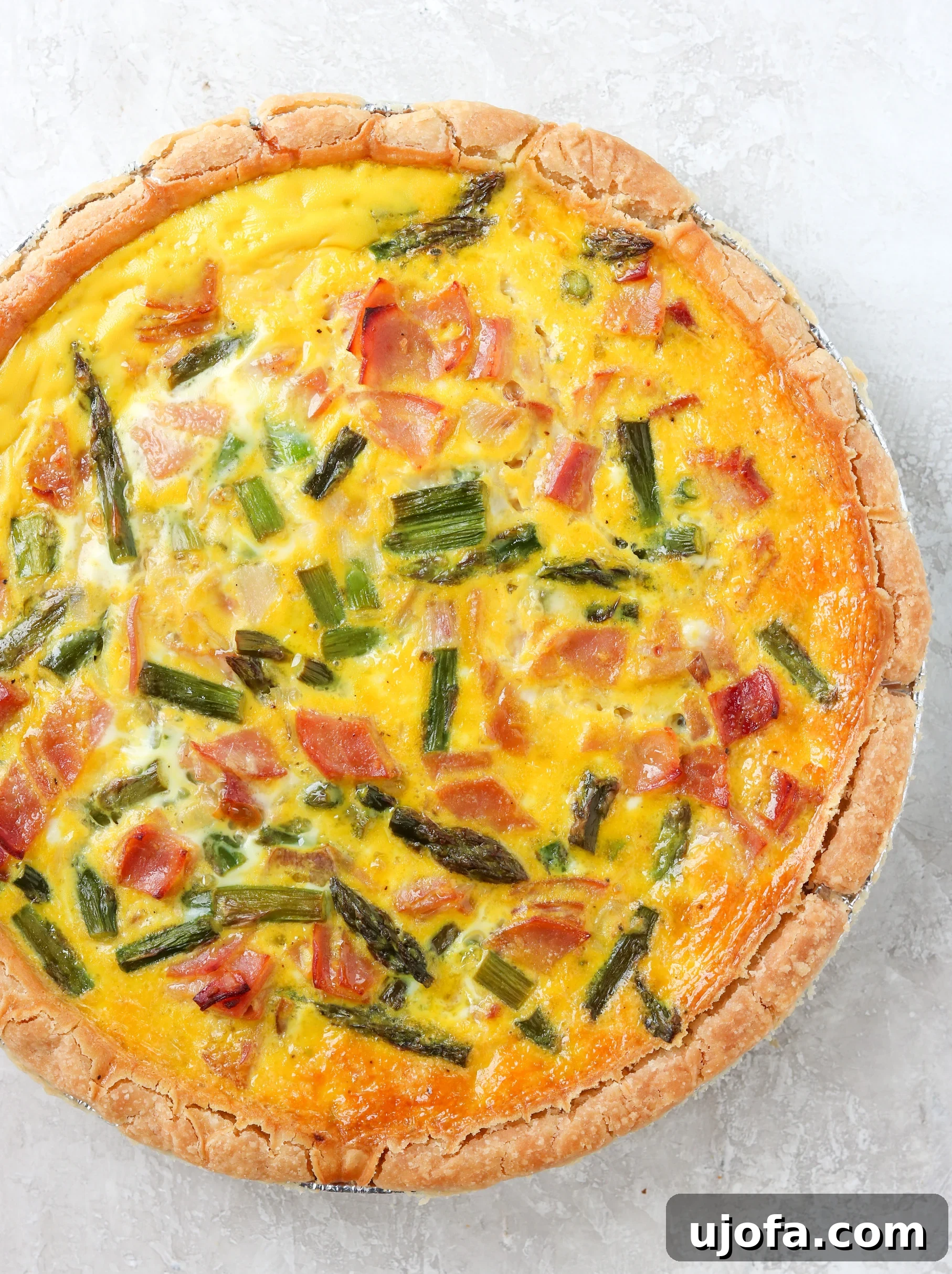 Gluten Free Quiche with ham and asparagus, golden brown crust and perfectly set filling