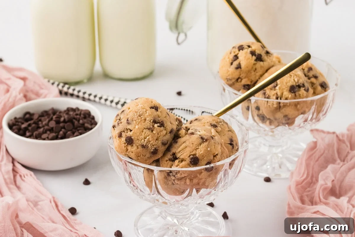 Guilt-Free Gluten-Free Cookie Dough 11 Glass dessert cups filled with scoops of gluten-free edible cookie dough, with mini chocolate chips and glasses of milk in the background.
