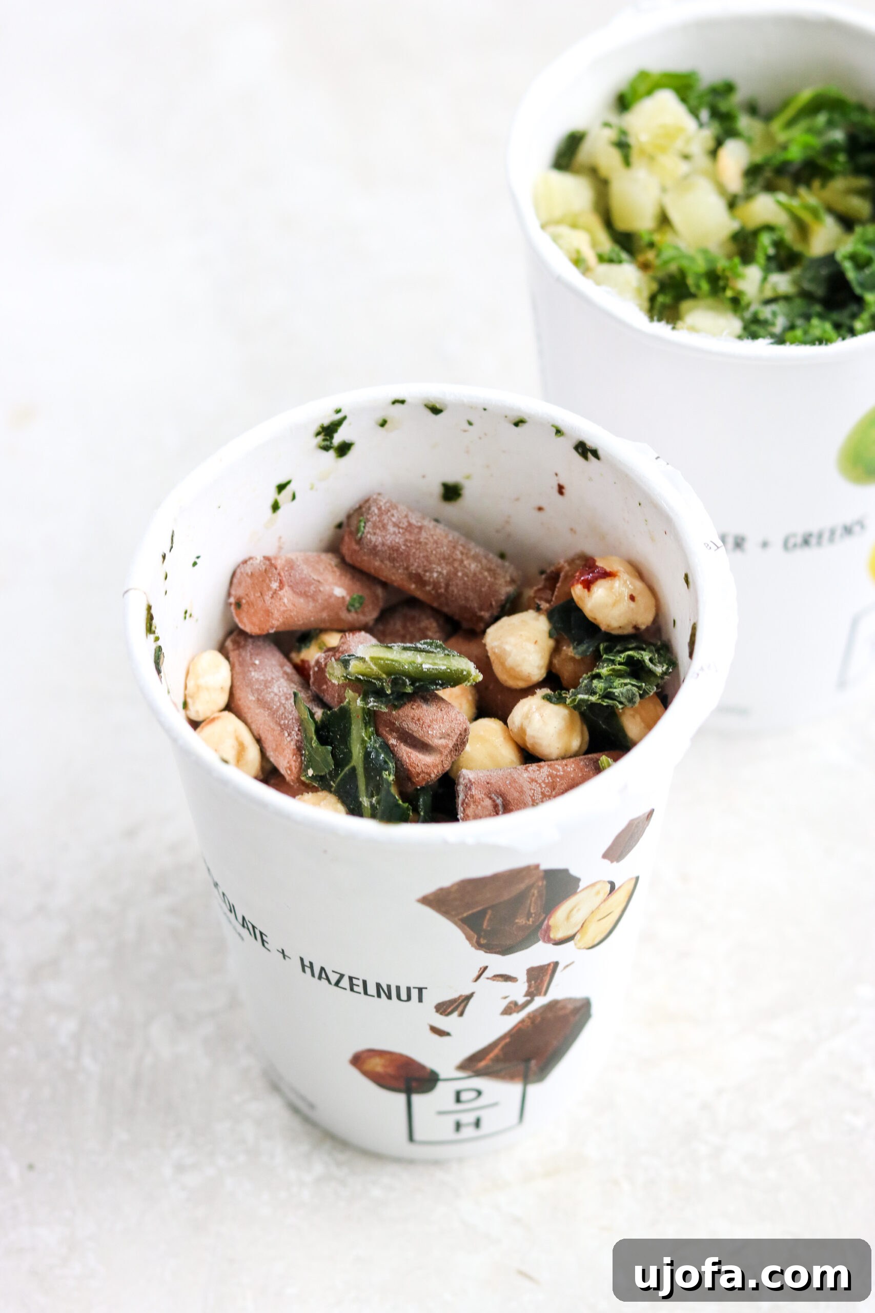 A Daily Harvest Chocolate Hazelnut smoothie, in its frozen state with the lid off, revealing the wholesome ingredients before blending.