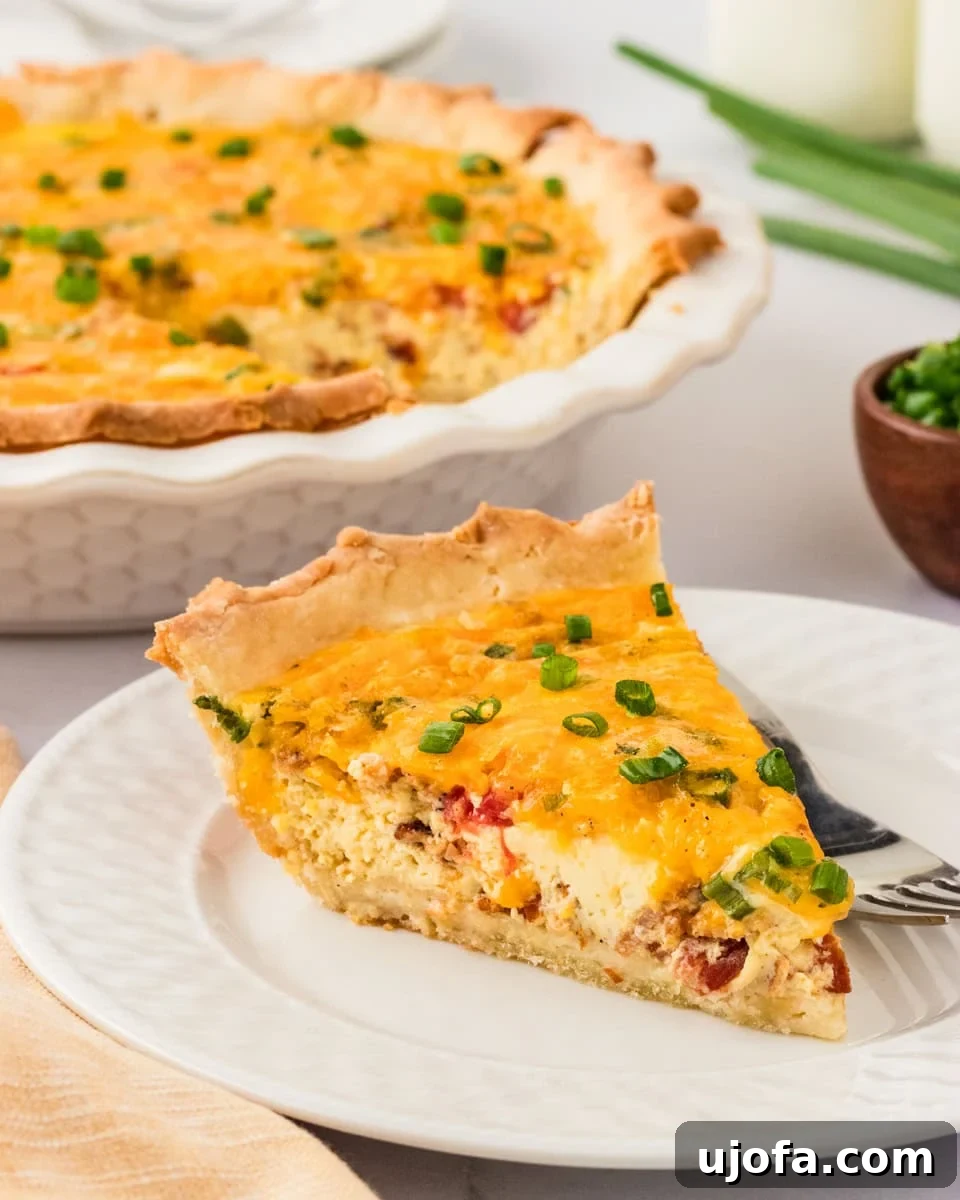 Ultimate Gluten-Free Quiche 2 A golden-brown slice of gluten-free quiche on a pristine white plate, garnished with vibrant green onions, with the full quiche visible in the soft background.