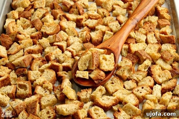Crafting Delicious Gluten-Free Croutons 3 A bowl of fresh homemade gluten-free croutons with a wooden spoon, showcasing their perfect golden texture and crunch.