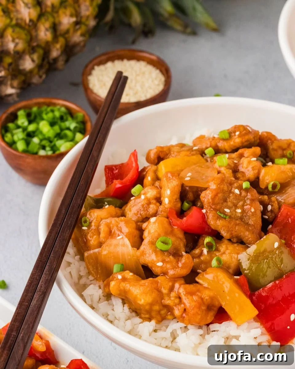 Flavorful Gluten-Free Chicken Feasts 11 A beautifully plated dish of gluten-free sweet and sour chicken, garnished with fresh vegetables and sesame seeds, ready to be enjoyed.