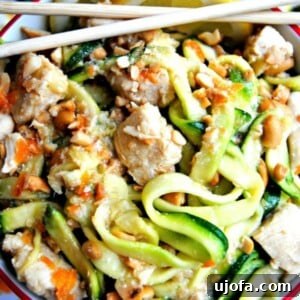 Flavorful Gluten-Free Chicken Feasts 23 A bowl of honey lemon ginger chicken zoodles, garnished with fresh lemon slices and chopsticks, showcasing a healthy and appealing meal.