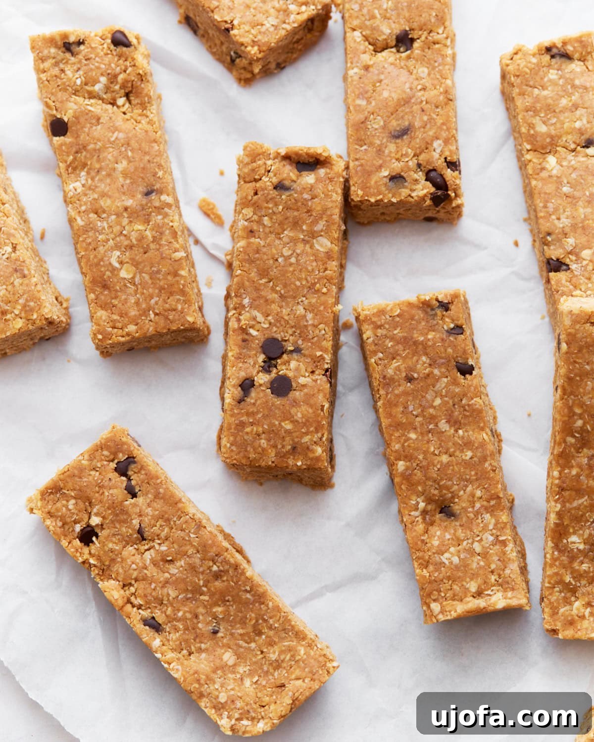 A batch of freshly prepared gluten-free granola bars displayed on parchment paper, ready for serving or storage.