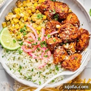 Street corn chicken and rice bowls with a yellow napkin and a fork in the bowl