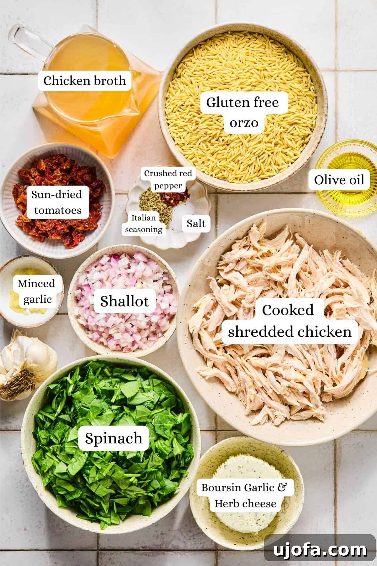 Marry Me Chicken Orzo ingredients labeled and arranged in nesting bowls on a white countertop.