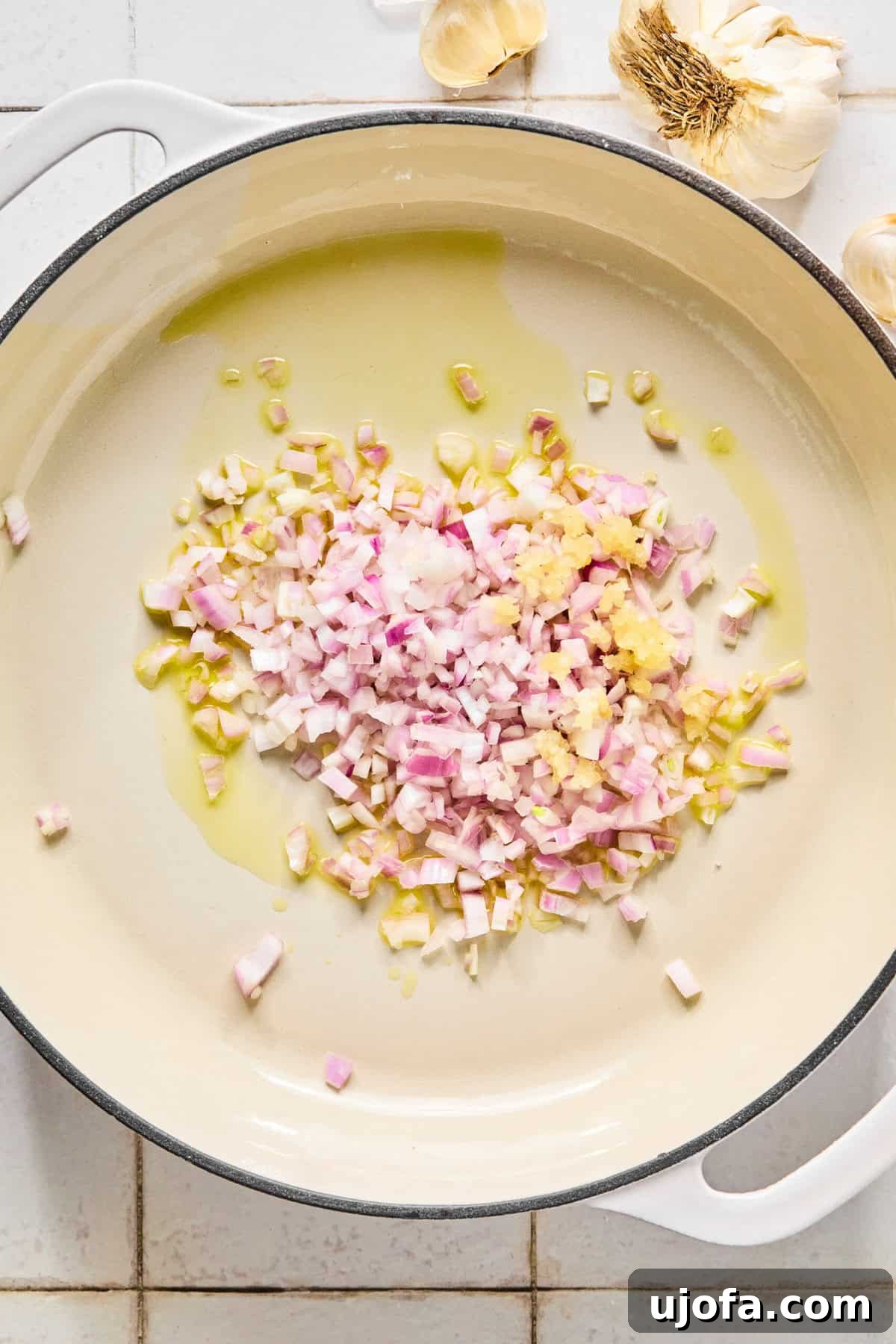 Creamy marry me chicken orzo served in a bowl with fresh basil and a fork.