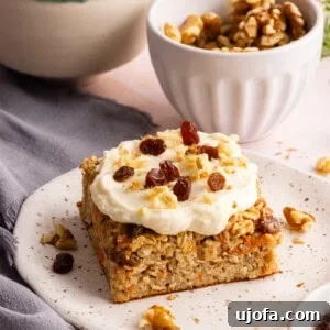 Protein-Packed Carrot Cake Oatmeal Bake 11 carrot cake baked oats with cream cheese frosting on a plate