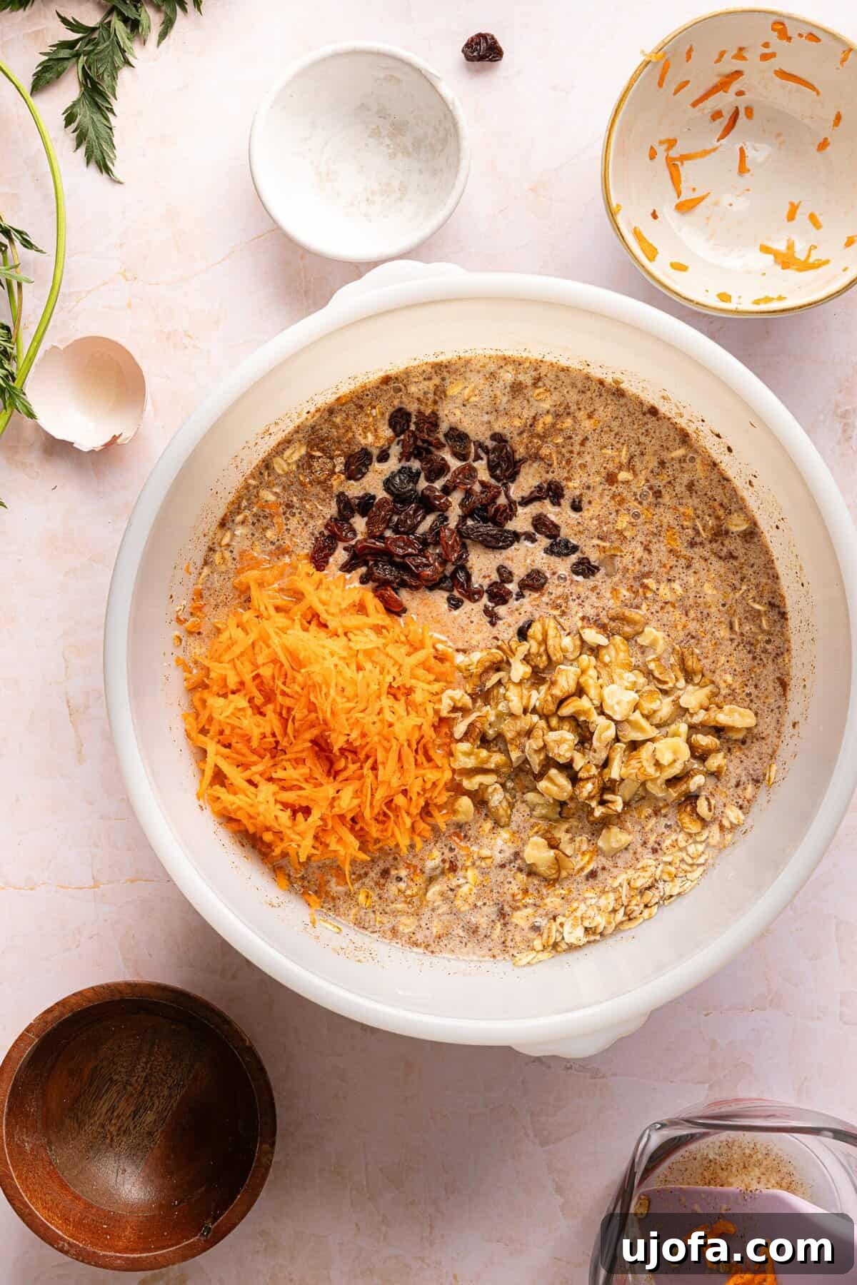 Protein-Packed Carrot Cake Oatmeal Bake 6 Finely shredded carrots, raisins, and chopped walnuts folded into carrot cake baked oats batter.
