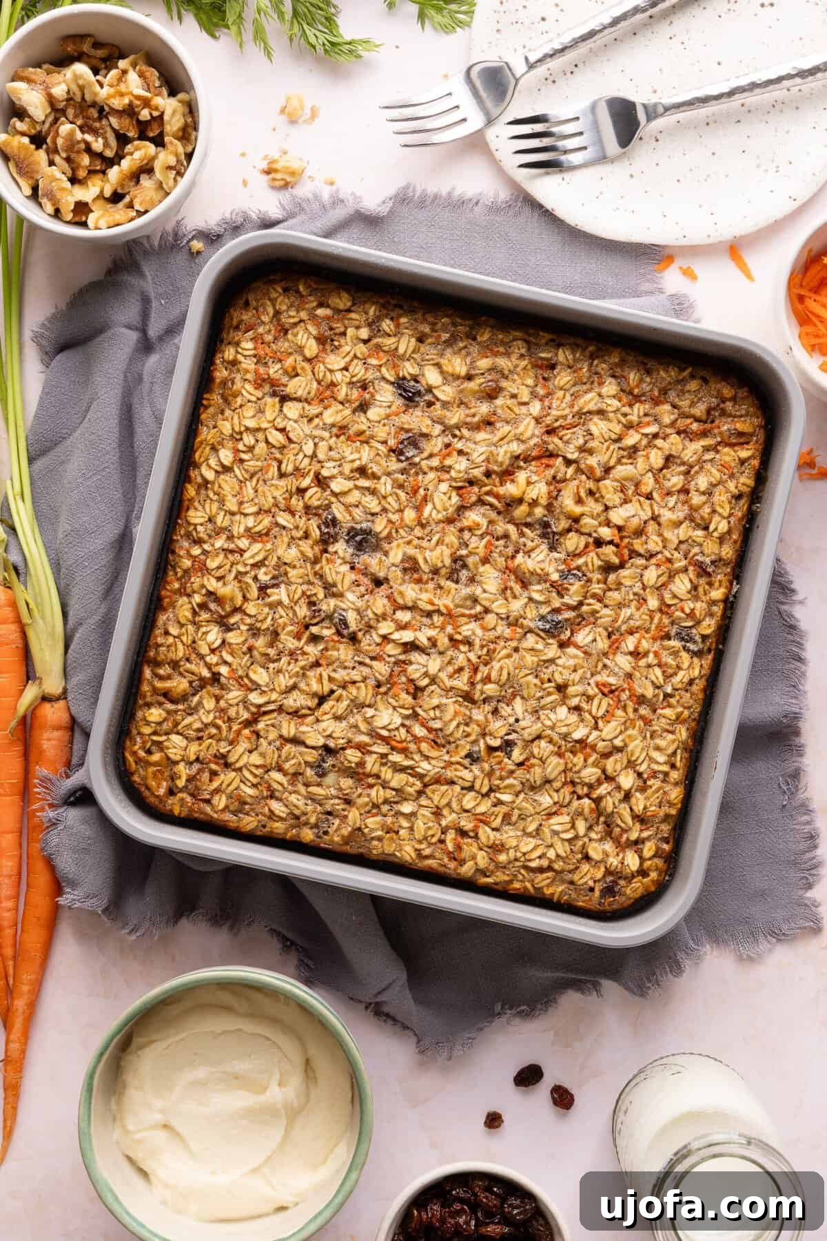 Protein-Packed Carrot Cake Oatmeal Bake 8 Baked carrot cake baked oats in a metal pan.