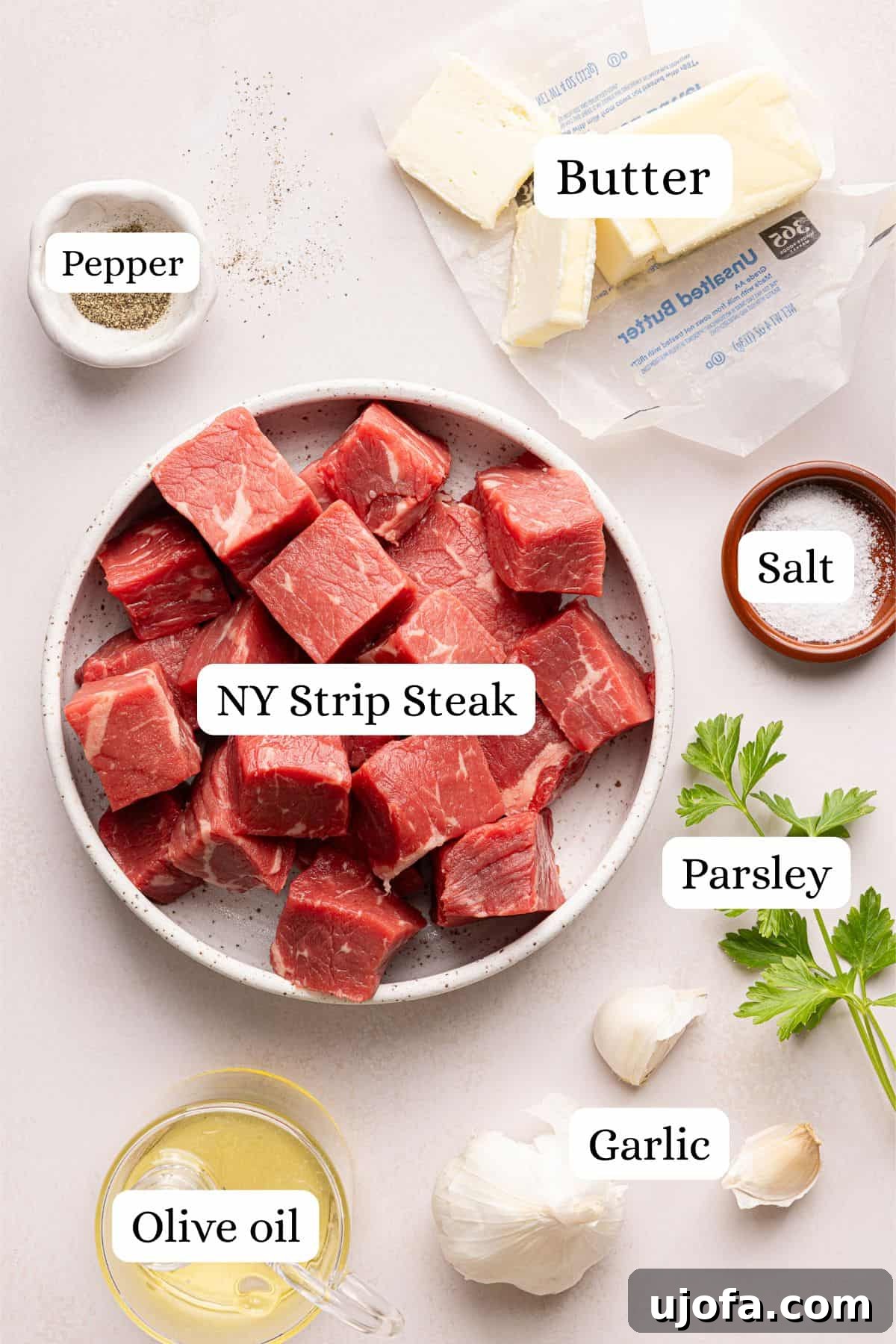 ingredients for garlic butter steak bites in nesting bowls
