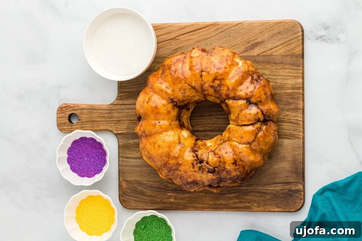 Mardi Gras Magic: Gluten-Free King Cake 16 Baked gluten free king cake flipped onto a wooden board, ready for glazing.