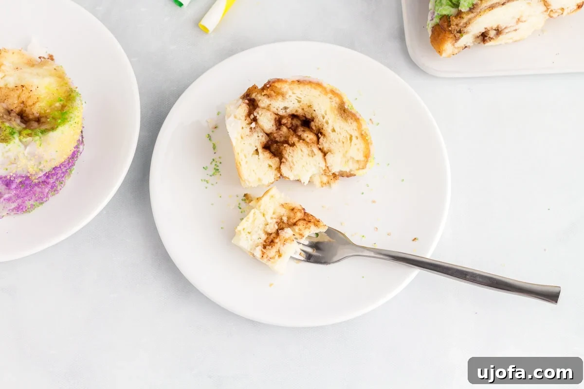 Mardi Gras Magic: Gluten-Free King Cake 19 Bite of gluten free king cake on a fork showing the soft interior and cinnamon sugar layers.