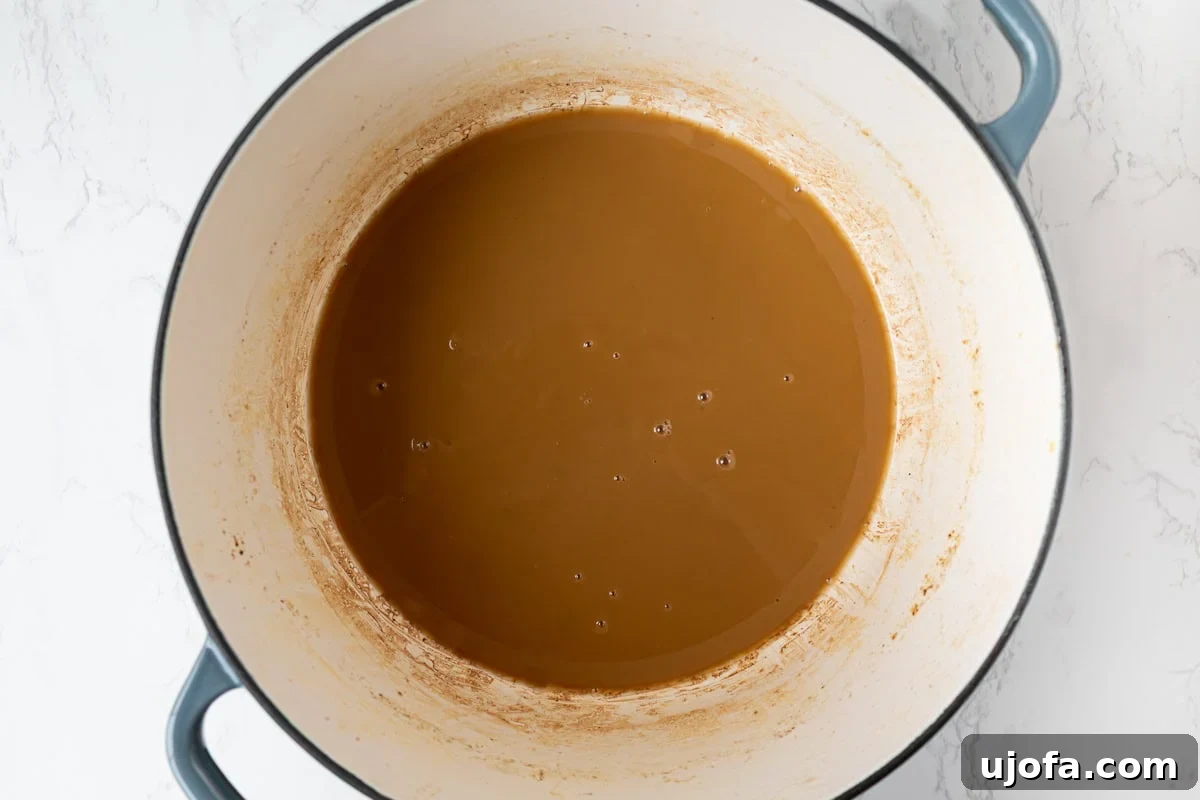 Delectable Gluten-Free Gumbo 10 A perfectly cooked gluten-free roux, smooth and dark peanut butter in color, simmering patiently in a Dutch oven, forming the heart of the gumbo.