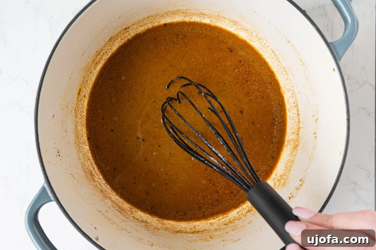 Delectable Gluten-Free Gumbo 11 The dark gluten-free roux being whisked with Cajun seasoning, creating a fragrant and intensely flavored base for the gumbo.