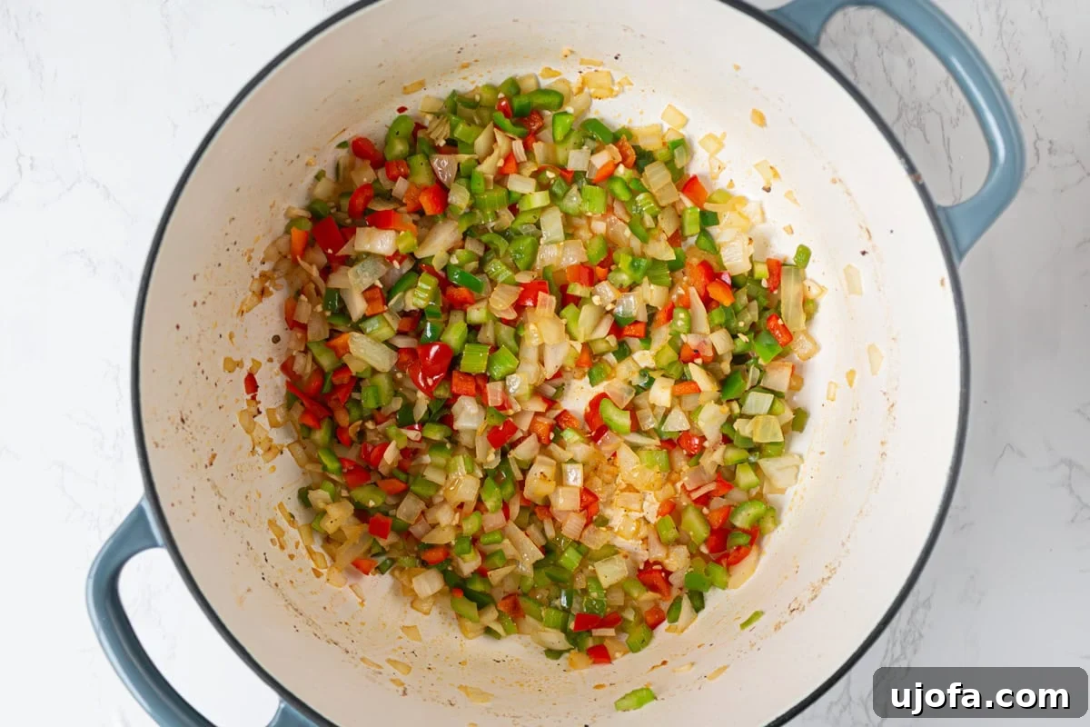 Delectable Gluten-Free Gumbo 9 The 'holy trinity' of diced onion, bell peppers, and celery, along with minced garlic, sautéing in the savory sausage drippings until tender and glossy.