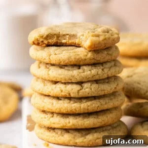 chocolate chipless cookies stacked on a white piece of wood