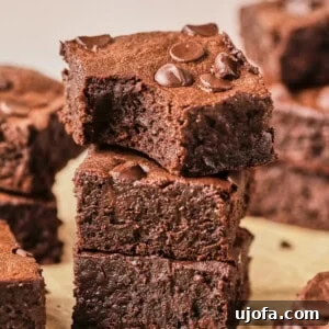 protein brownies stacked up on parchment paper