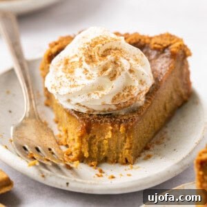 gluten free pumpkin pie on a plate topped with whipped cream