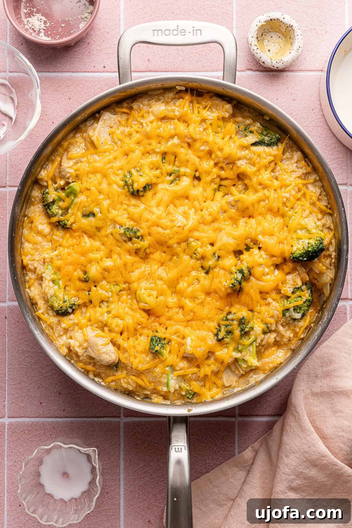 Ultimate Chicken Broccoli Rice Bake 9 A skillet filled with golden, cheesy chicken broccoli rice casserole, topped with melted cheese and ready to serve.
