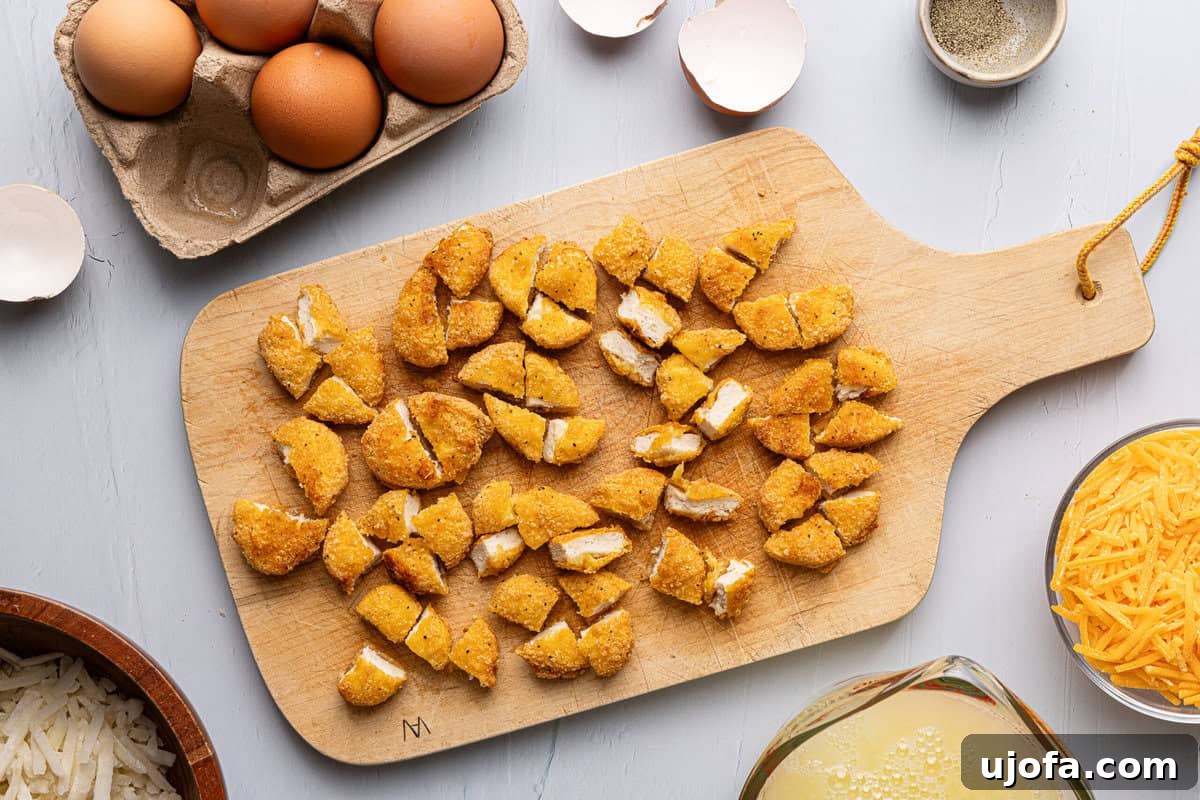 Chick-fil-A Inspired Hash Brown Breakfast Bowls 4 chopped up chicken nuggets on a cutting board, ready for the bowls