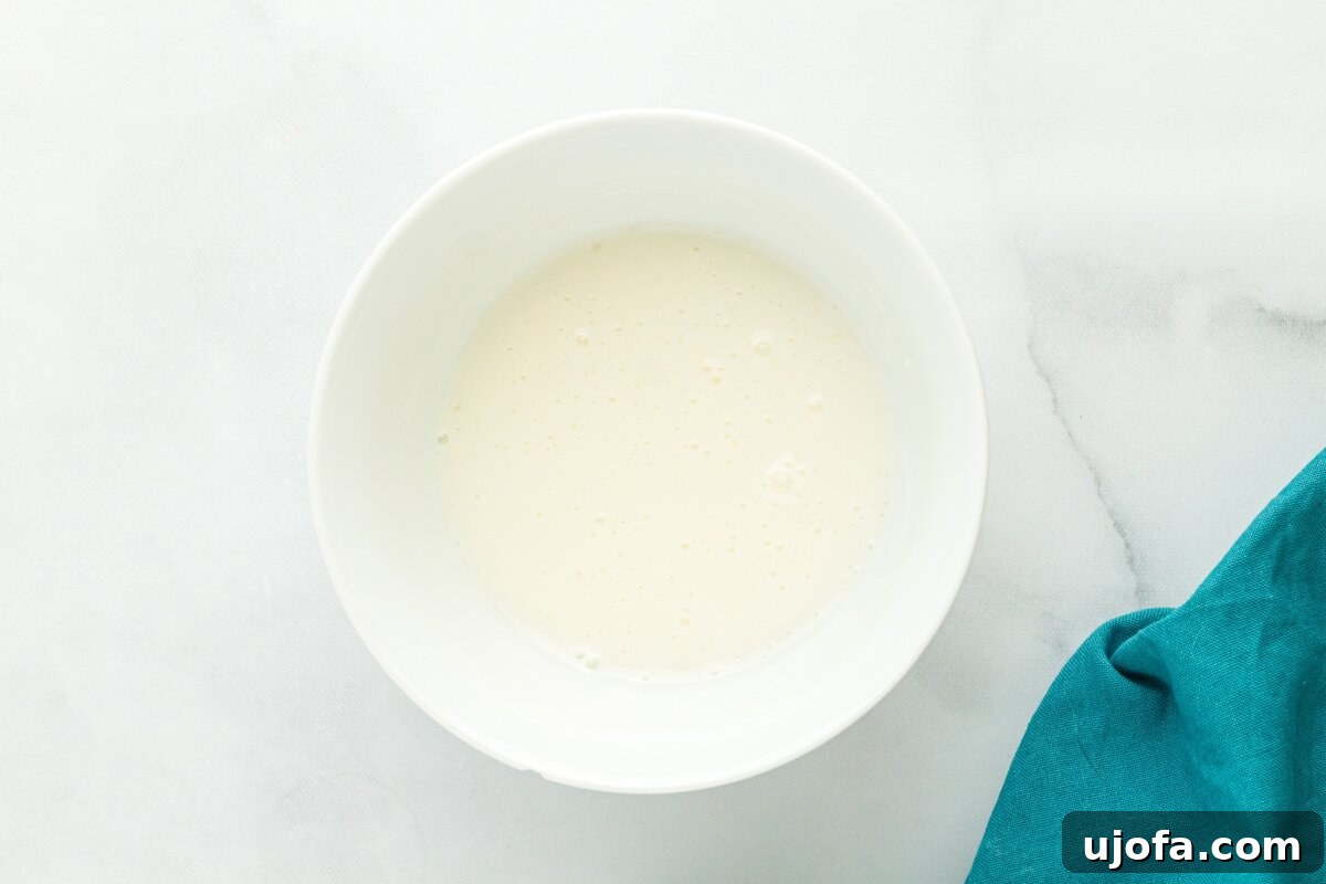 Simple lemon glaze made with powdered sugar and fresh lemon juice in white bowl