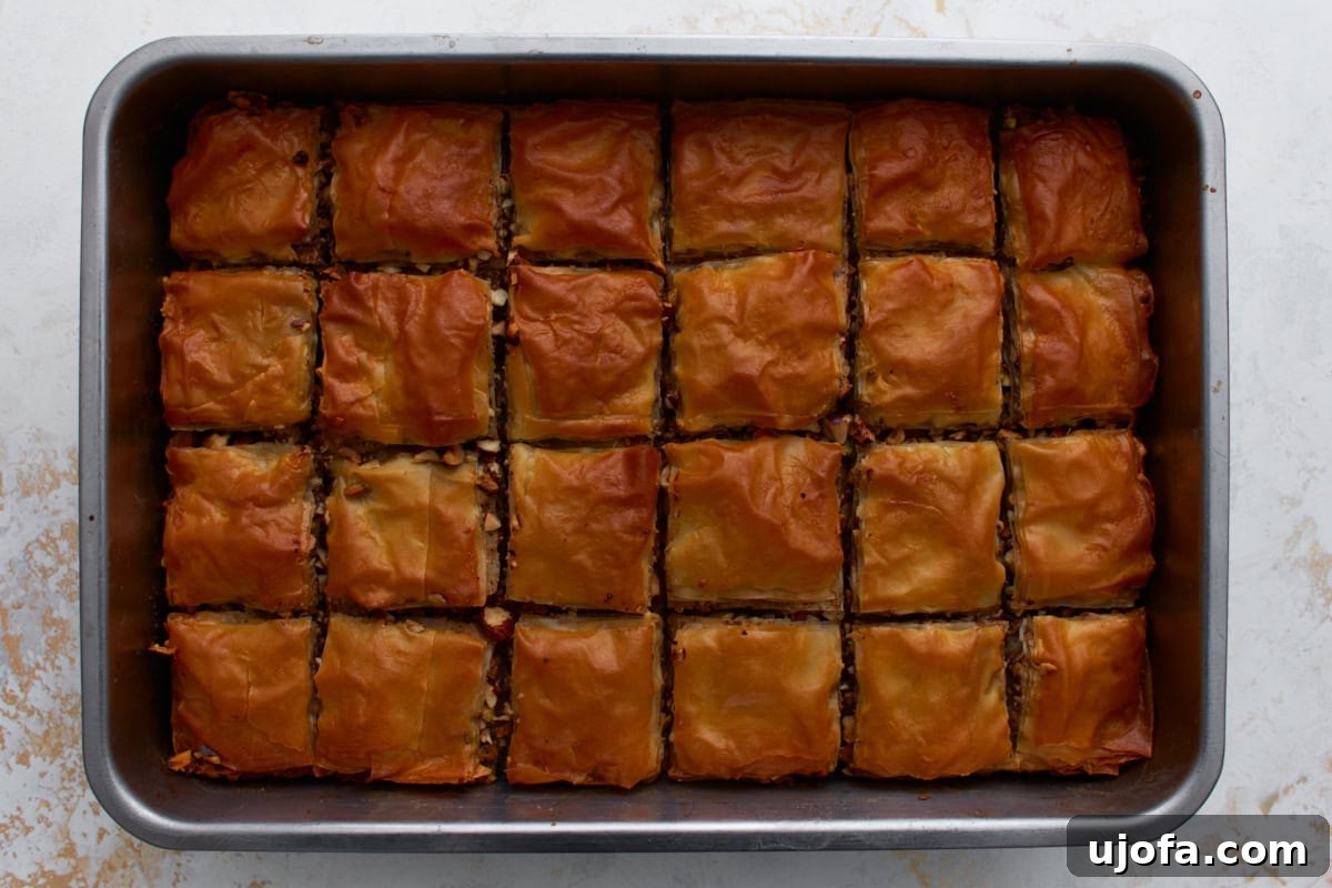 Golden brown gluten-free baklava baked in a rectangular pan.