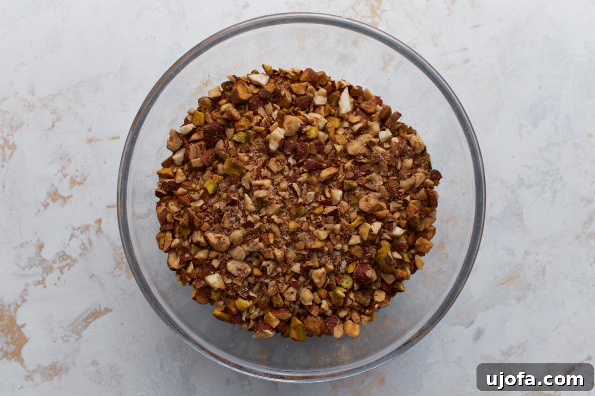 Chopped mixed nuts with cinnamon and sugar in a bowl for the baklava filling.