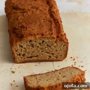 Sliced oat flour bread loaf showing soft, dense crumb and golden brown crust on a wooden cutting board