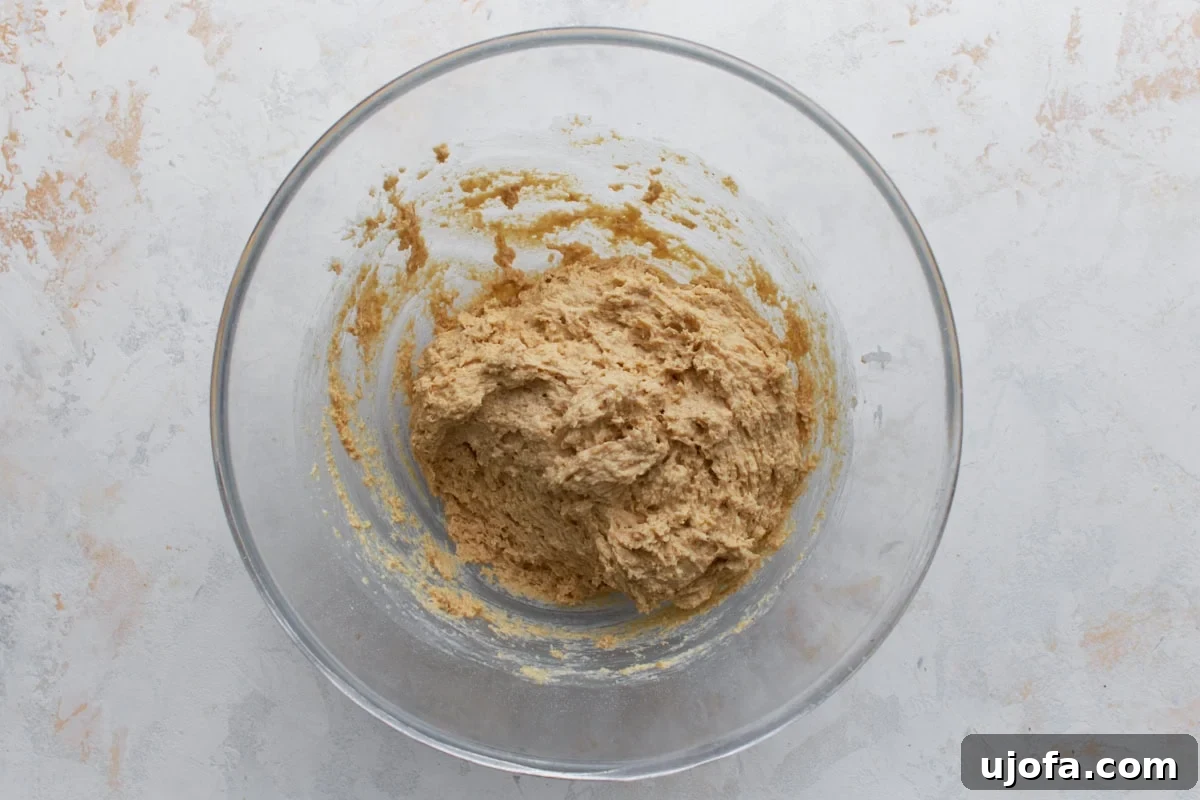 Wholesome Oat Bread 6 Thick oat flour bread batter in a glass bowl showing dense, sticky texture before baking