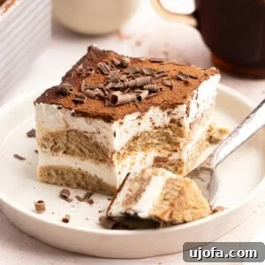 Gluten-Free Tiramisu Recipe: Authentic Italian Dessert Without Gluten 17 a slice of gluten free tiramisu with a fork taking a bite
