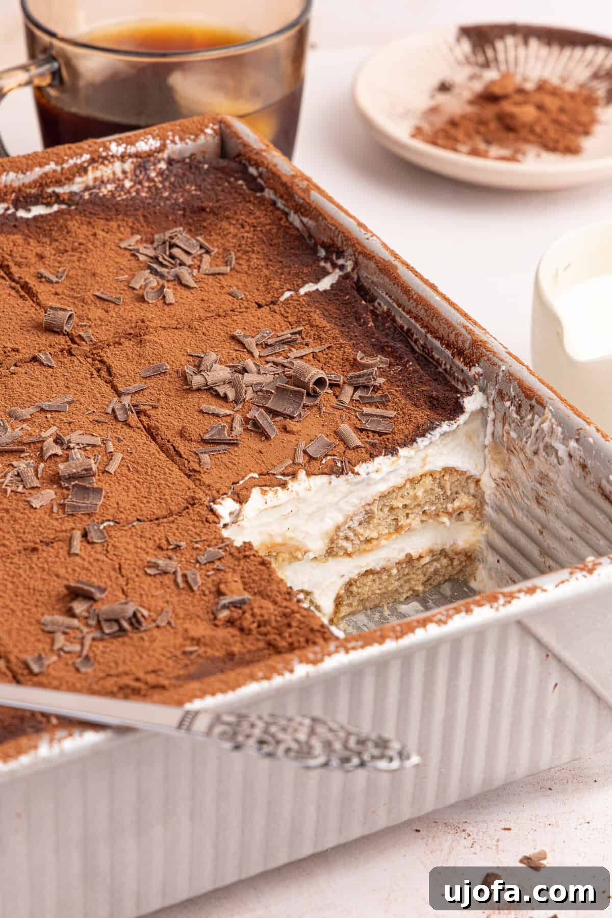 Gluten-Free Tiramisu Recipe: Authentic Italian Dessert Without Gluten 10 a side view of tiramisu with a slice taken out of the pan