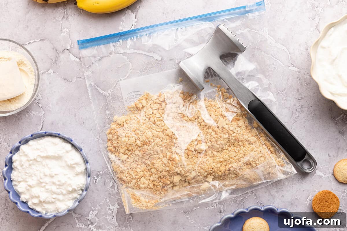 Protein-Packed Banana Pudding Cups for Muscle Fuel 4 crushed vanilla wafers in a plastic bag with a meat mallet