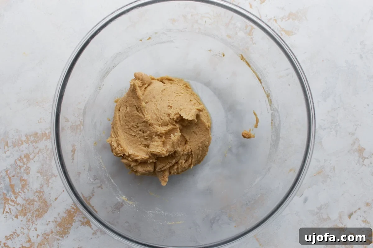 Buckwheat cookie dough fully mixed and formed into a soft ball inside a glass bowl
