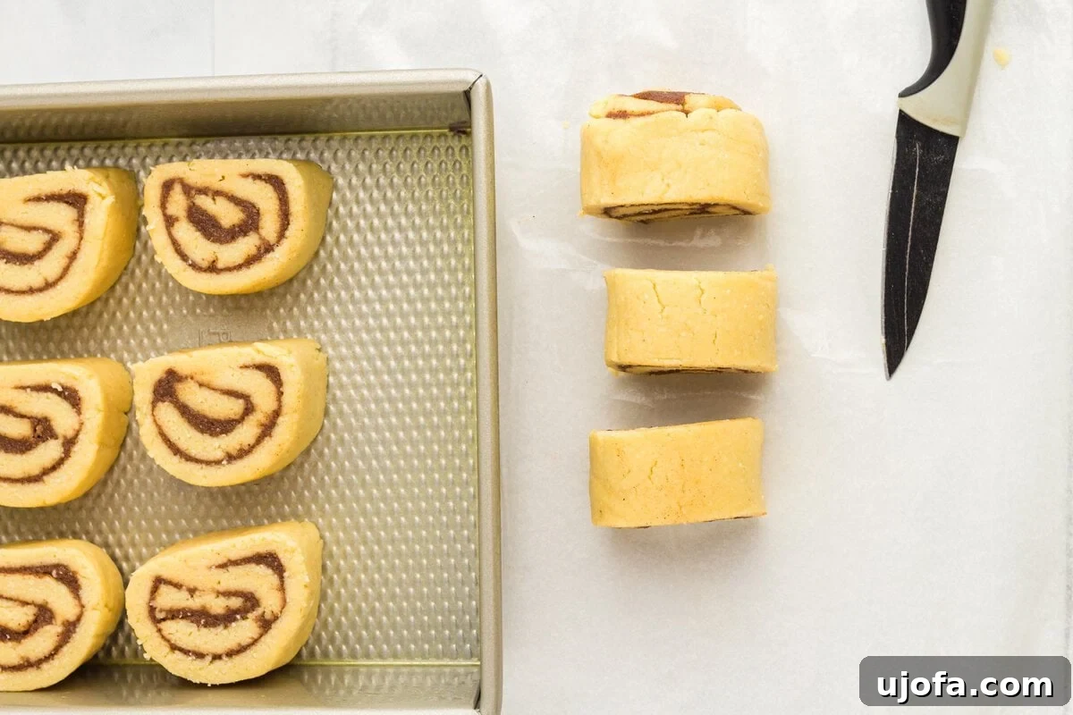Sliced keto cinnamon rolls arranged on a baking pan before baking
