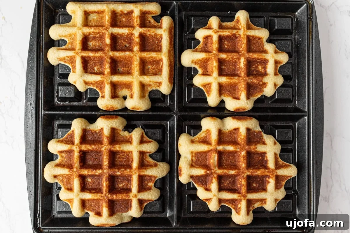 Coconut Flour Waffles: Light, Crispy Grain-Free Recipe 7 Gluten-free coconut flour waffles cooking in a waffle iron until golden brown and crisp