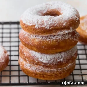 Gluten-Free Mochi Donuts Recipe: Chewy, Crispy & Irresistible 3 Stack of gluten-free mochi donuts dusted with powdered sugar on a cooling rack
