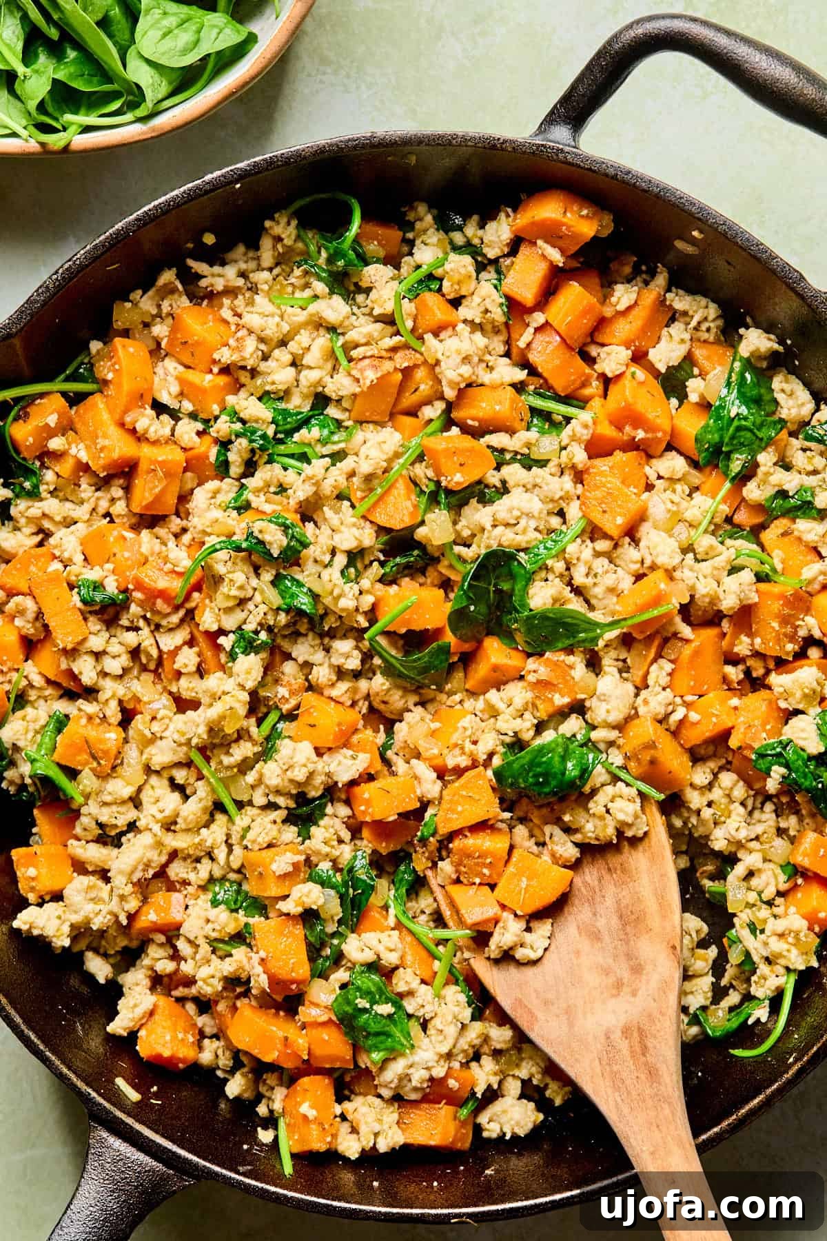 One-Skillet Turkey and Sweet Potato Hash Recipe 6 sweet potato turkey skillet with a wooden spoon