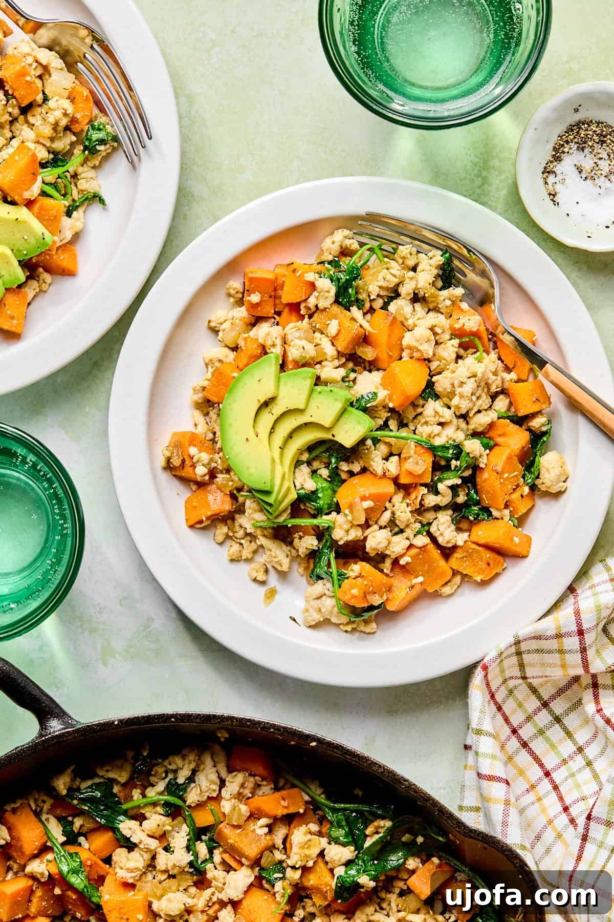 One-Skillet Turkey and Sweet Potato Hash Recipe 8 sweet potato breakfast hash in a white bowl next to a skillet