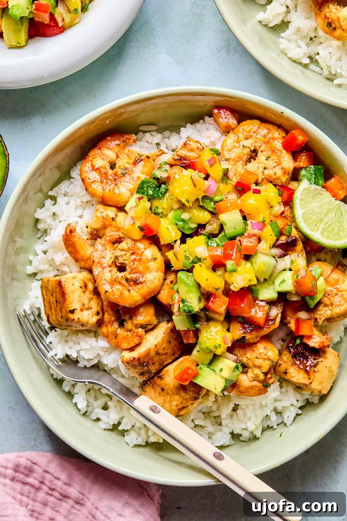 cilantro lime chicken and shrimp over rice with mango salsa
