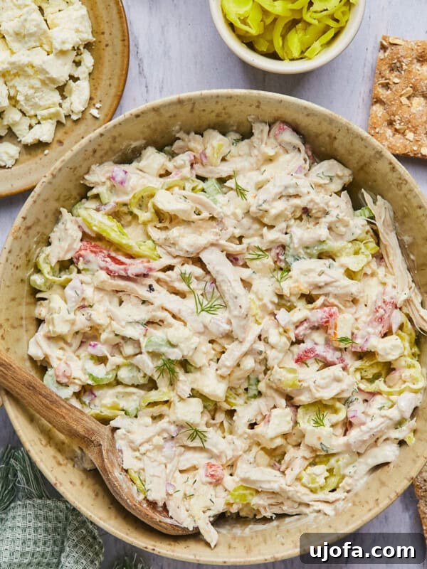 Gluten-Free Italian Pasta Salad Recipe for Flavorful Picnics 11 feta chicken salad in a bowl with a wooden spoon