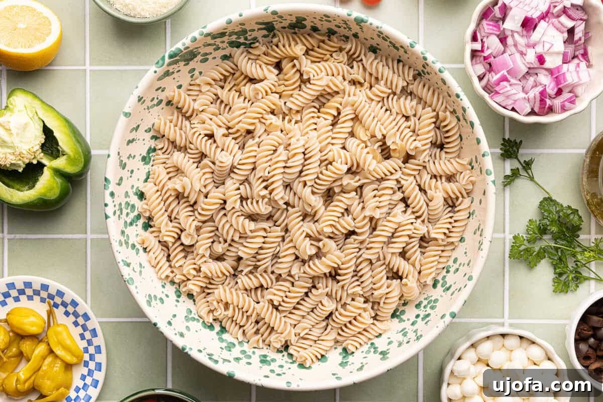 Gluten-Free Italian Pasta Salad Recipe for Flavorful Picnics 5 Cooked gluten-free fusilli pasta rinsed with cold water, drained, and in large mixing bowl.