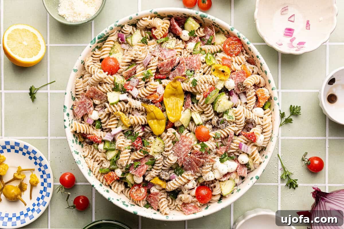 Gluten-Free Italian Pasta Salad Recipe for Flavorful Picnics 6 Gluten free pasta salad assembled in a decorative serving bowl and topped with extra pepperoncinis.