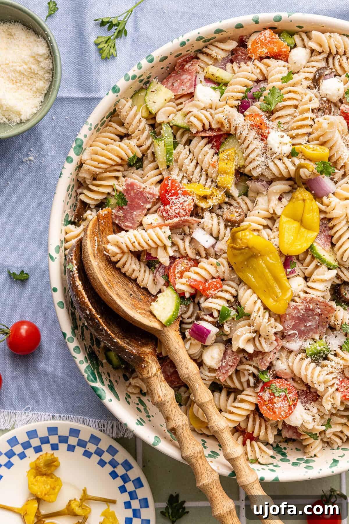 Gluten-Free Italian Pasta Salad Recipe for Flavorful Picnics 7 Gluten free pasta salad served in a decorative bowl with wooden serving spoons ready for serving.
