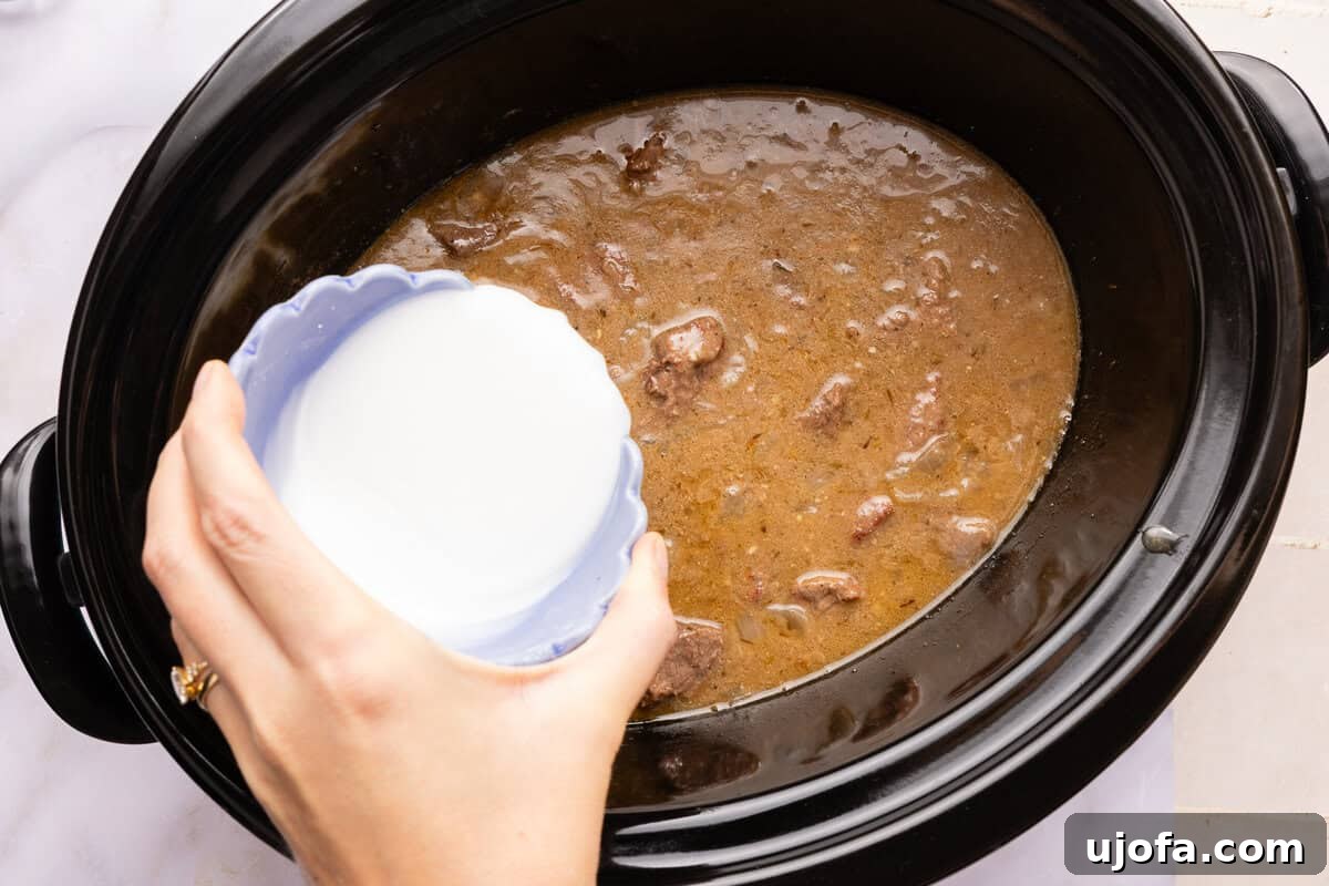 arrowroot slurry being poured into a slow cooker