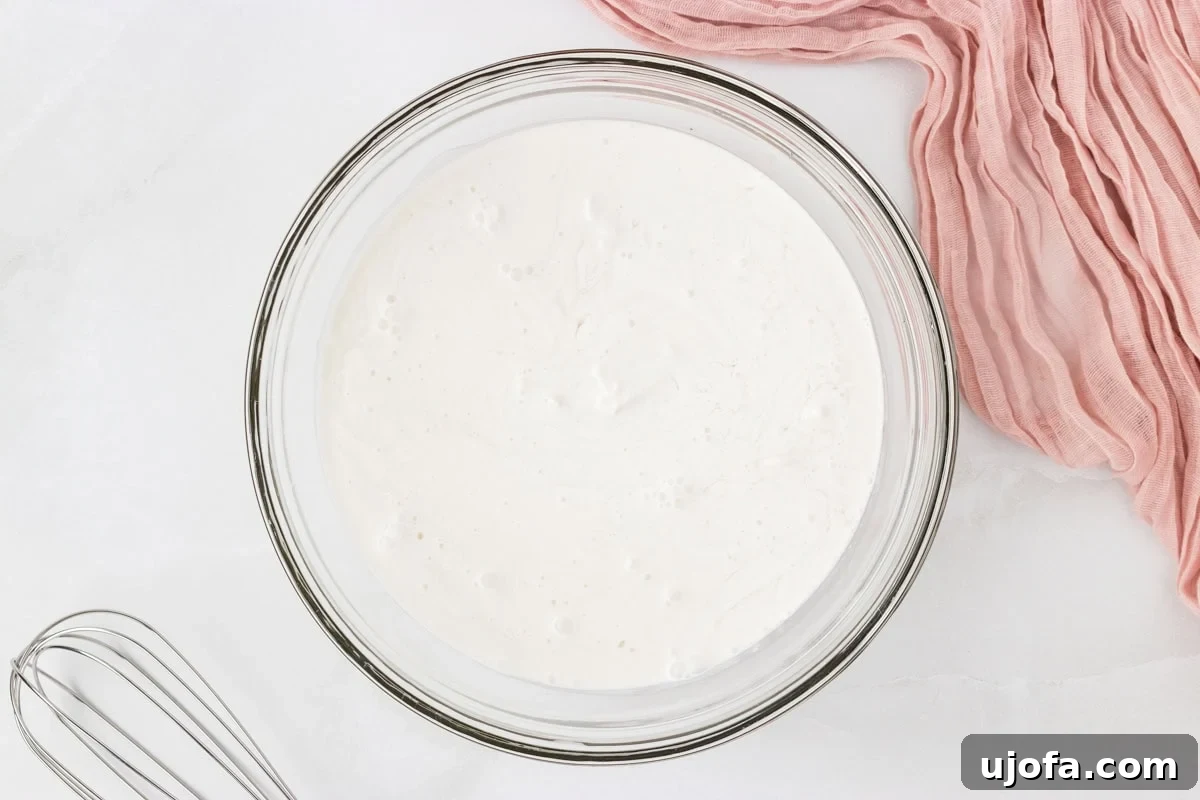 Refreshing Coconut Sorbet Recipe: Light, Dairy-Free Dessert 5 Coconut sorbet base mixed in a glass bowl before freezing.
