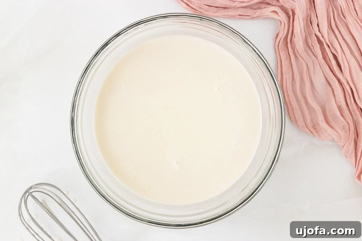 Refreshing Coconut Sorbet Recipe: Light, Dairy-Free Dessert 6 Smooth coconut sorbet mixture in a glass bowl after whisking together the ingredients.