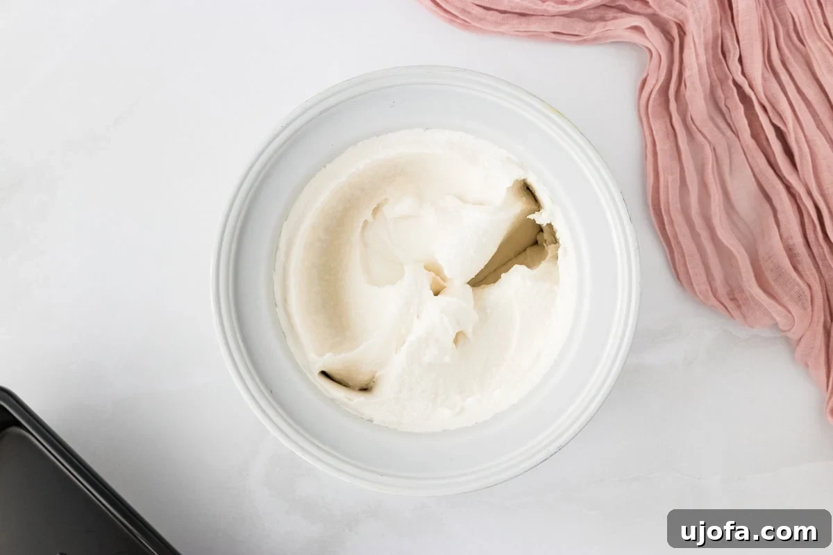 Refreshing Coconut Sorbet Recipe: Light, Dairy-Free Dessert 7 Frozen coconut sorbet in a container
